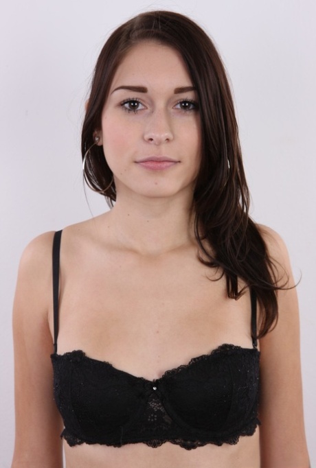 Young amateur Zuzana strips jeans and panties to stand naked for the camera