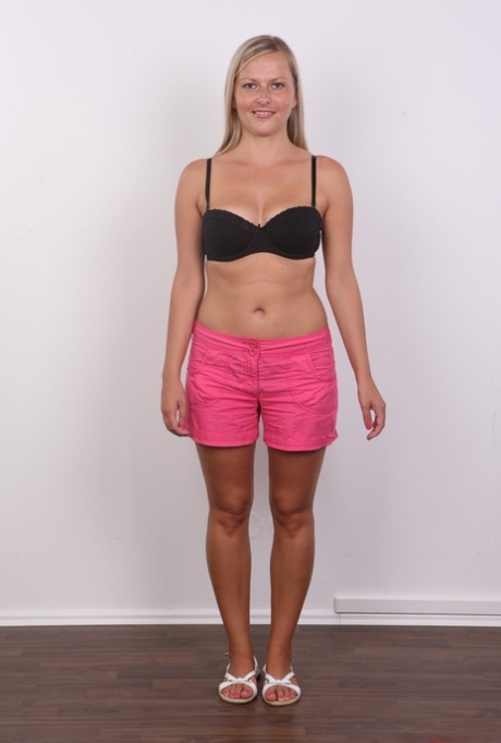 Amateur blonde Petra doffs her black bra and panties for a naked mugshot