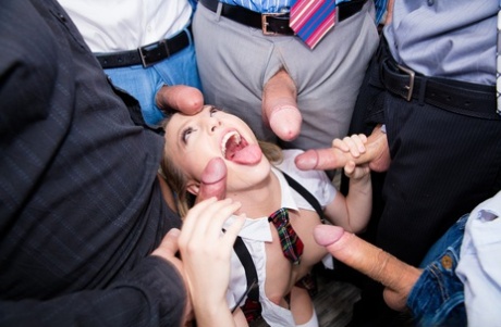 Young pornstar Aubrey Star receiving blowbang in schoolgirl clothes
