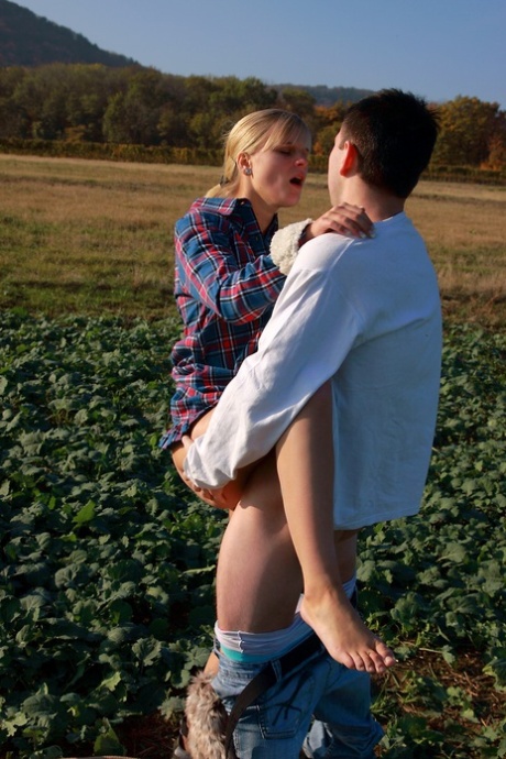 Blonde girl and her boyfriend have sex in a crop field away from prying eyes