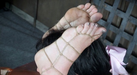 Submissive female London River is tied up with rope and spanked