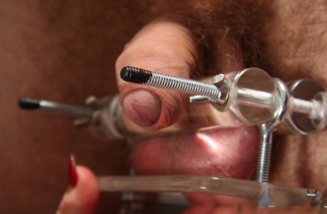 Dominant brunette Nyxon tortures a restrained man's tiny cock and balls