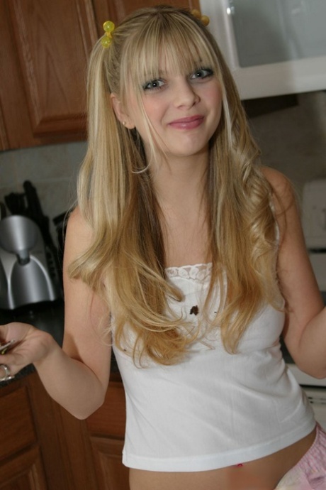 Cutie Jana Jordan in socks & frilly skirt flashes white panties in the kitchen