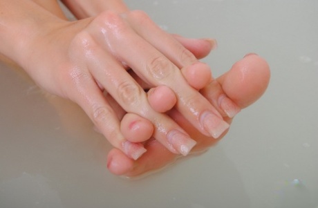 Young blonde girl Codie Sweets plays with her pretty feet while in a bathtub