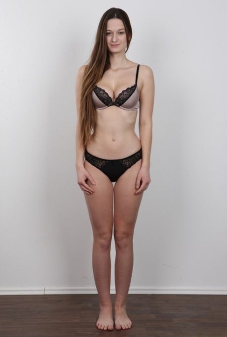 Long haired girl takes off all her clothes to model in the nude