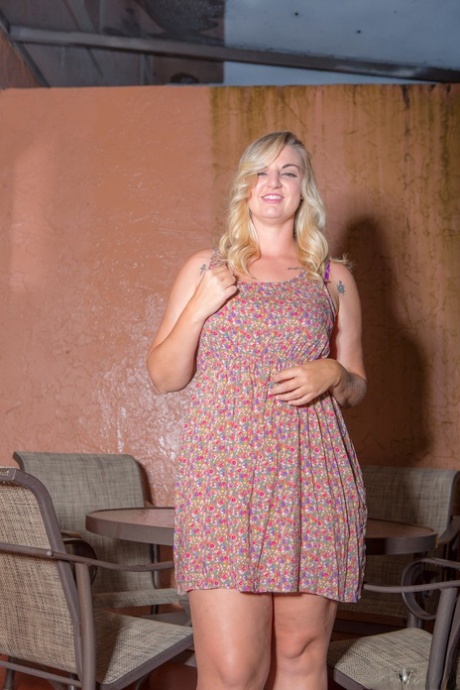 Mature fatty Carrie strips off her dress to model her big BBW ass and tits