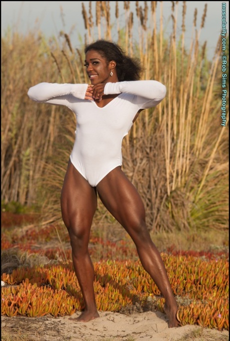 Ebony bodybuilder Jaquita Persons Taylor flexes outdoors in a SFW fashion