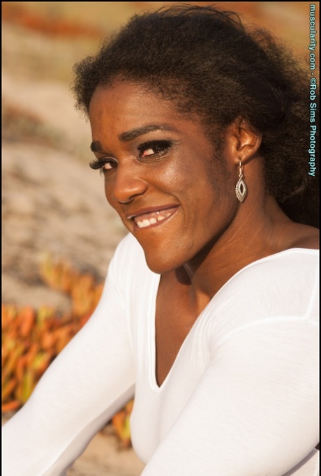 Ebony bodybuilder Jaquita Persons Taylor flexes outdoors in a SFW fashion