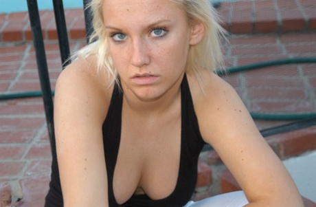 Blonde amateur Jordan smokes a cigarette while showing some cleavage