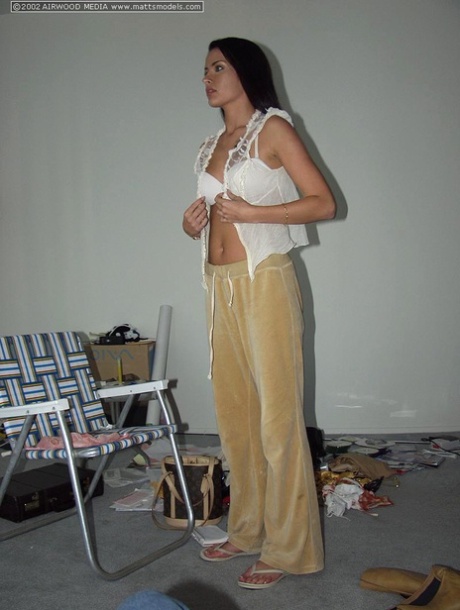 Dark haired amateur Isabella takes a smoke break while modeling in the nude