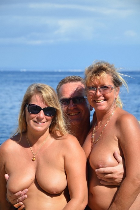 Two blonde women with saggy tits enjoy hot suck and fuck in beach threesome