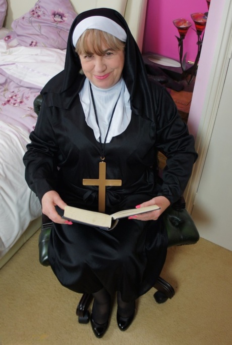 Mature nun Speedy Bee and partakes in strapon lesbian sex with another nun