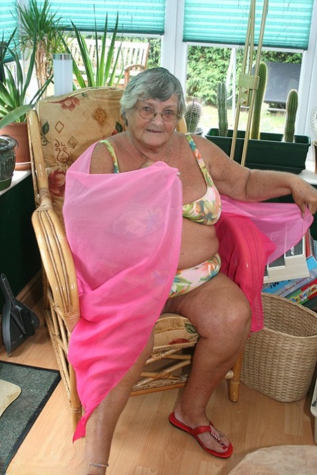 Horny old granny in glasses disrobes to reveal huge saggy tits & big BBW ass