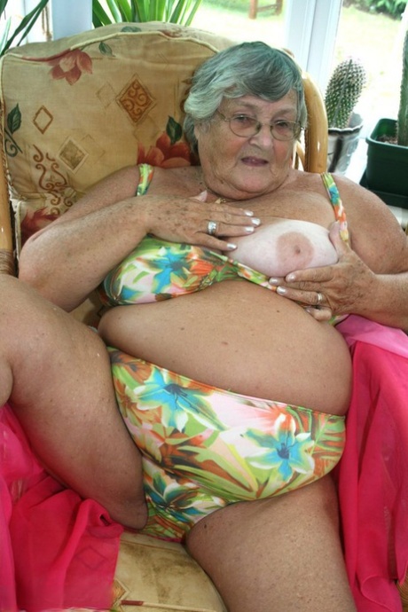 Horny old granny in glasses disrobes to reveal huge saggy tits & big BBW ass