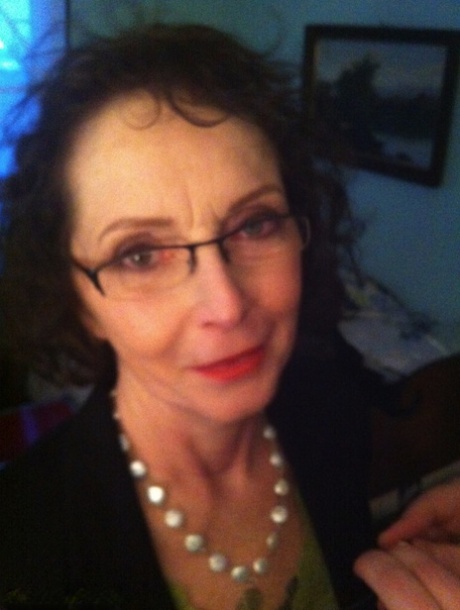 Curly haired mature woman likes sending her younger partner provocative photos