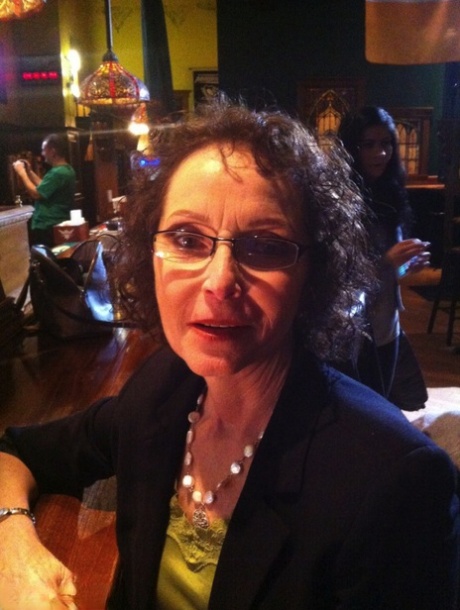Curly haired mature woman likes sending her younger partner provocative photos