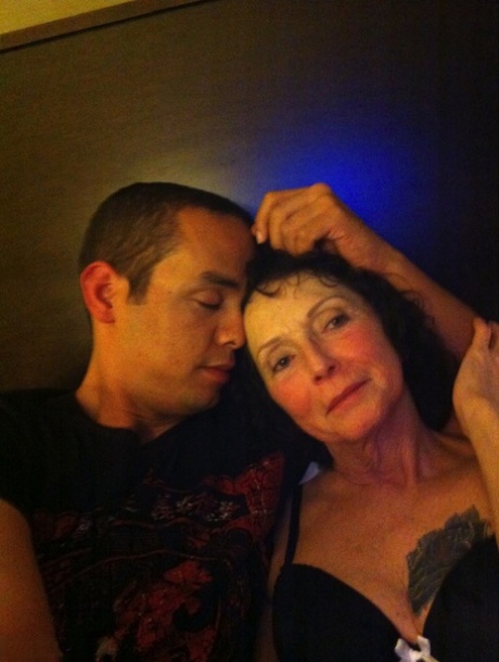 Curly haired mature woman likes sending her younger partner provocative photos