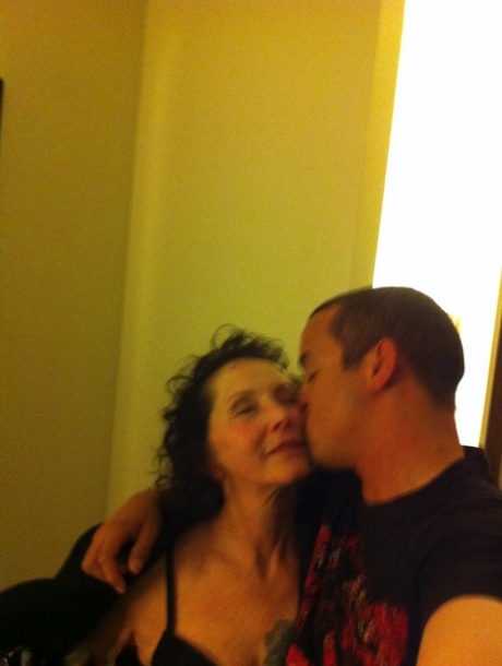 Curly haired mature woman likes sending her younger partner provocative photos