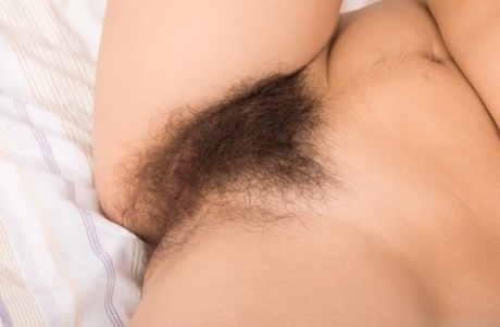 Busty babe Ole Nina strips down naked & spreads her extremely hairy pussy