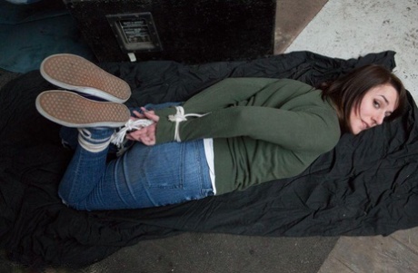 Two white girls are hogtied and ball gagged in sweaters and jeans