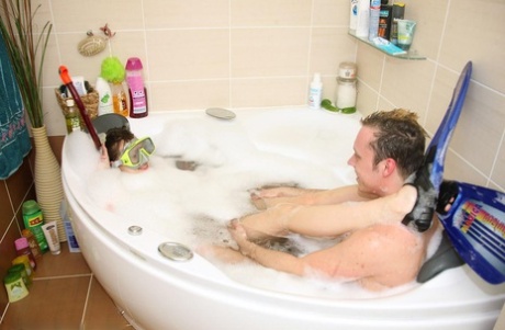 Cute teen engages in oral sex while wearing flippers in a bathtub