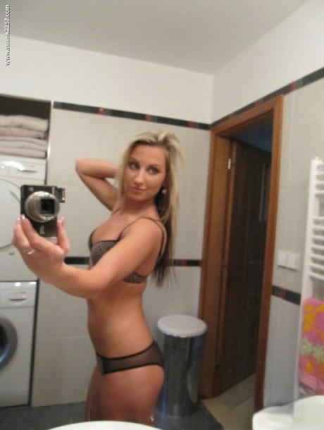 Blonde amateur gets totally naked while taking self shots in a bathroom mirror