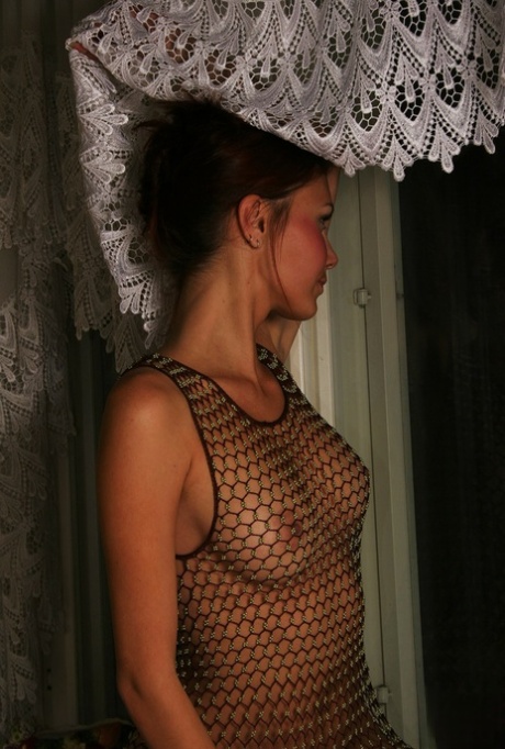 Teen amateur Natasha removes a revealing mesh dress to pose nude on her bed