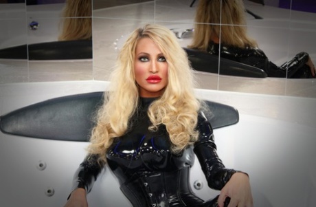 Seductive blonde temptress with big tits strikes hot solo poses