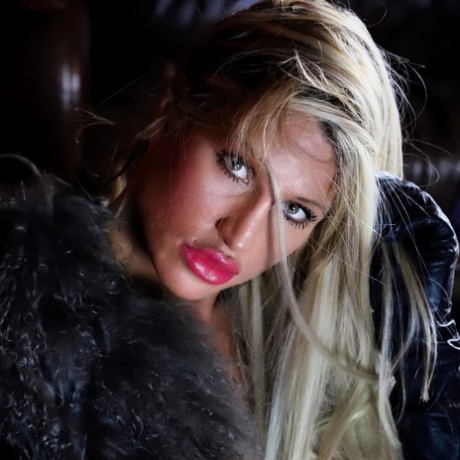 Seductive blonde temptress with big tits strikes hot solo poses