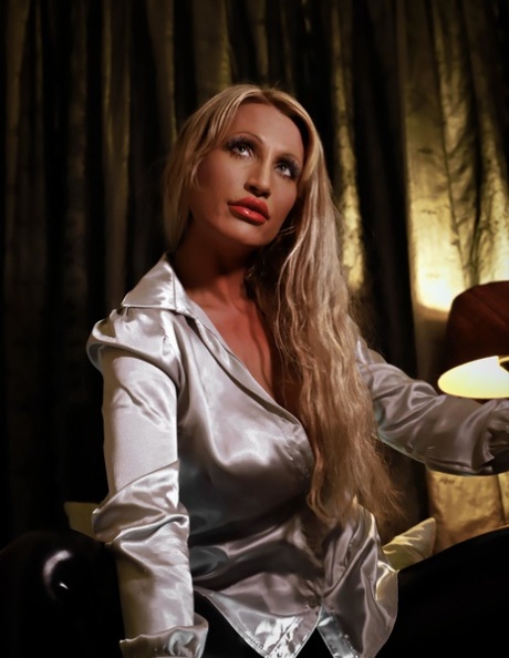Seductive blonde temptress with big tits strikes hot solo poses