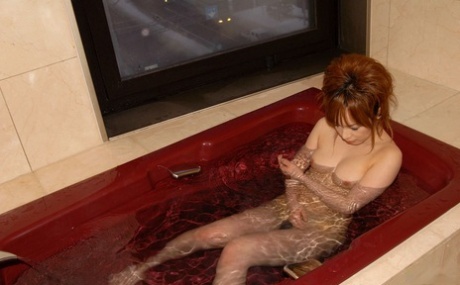 Cute redheaded Japanese teen Rinko gets naked to bathe on a winter's day