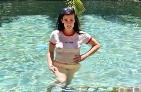 Teen girl with black hair rides a dildo before showing her bare ass in a pool