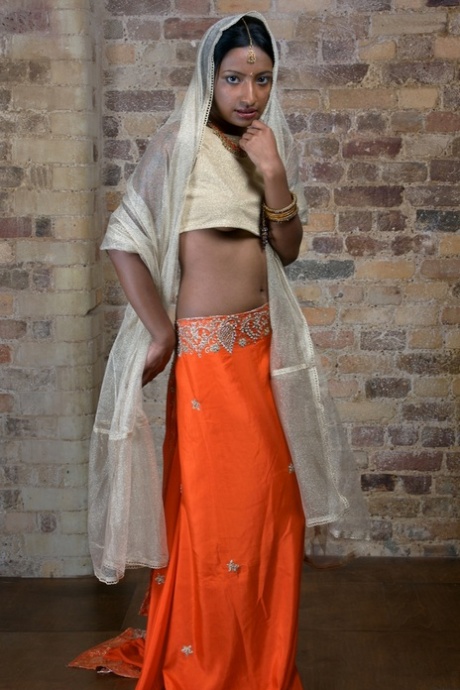 Indian model with tattoos exposes her firm tits in traditional clothing