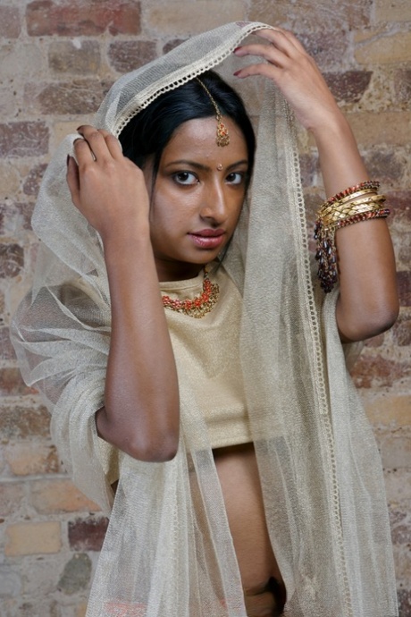 Indian model with tattoos exposes her firm tits in traditional clothing