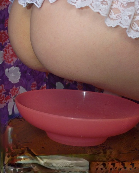 Redhead maid takes a pee into a bowl while on her menstrual cycle