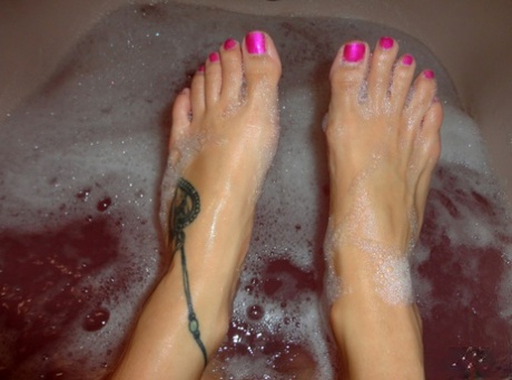 Teen solo girl Andi Land takes self shots during a bubble bath