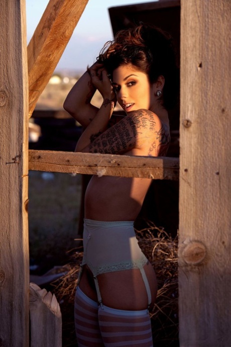 Hot model Kaya Jane poses in a garter belt and hosiery at an abandoned site