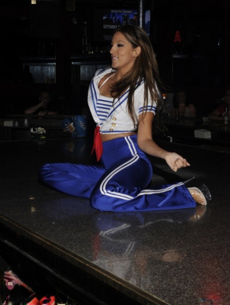 Caucasian stripper salutes before peeling off her clothes onstage