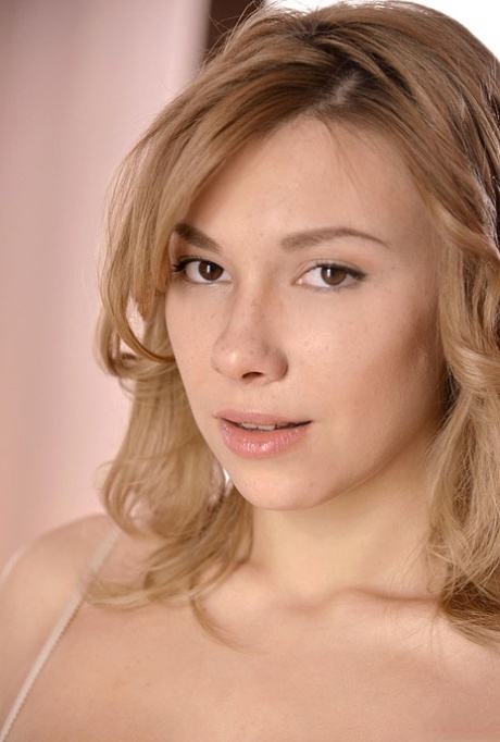 Solo girl Karina D removes her bra and panty set wearing flesh toned stockings