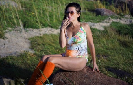 Mature woman Diana Ananta wears knee-high boots during no panty upskirt action
