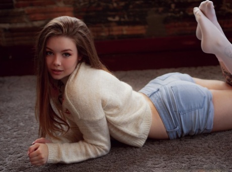 Gorgeous girl Lana Lea removes a sweater and shorts to model in the nude