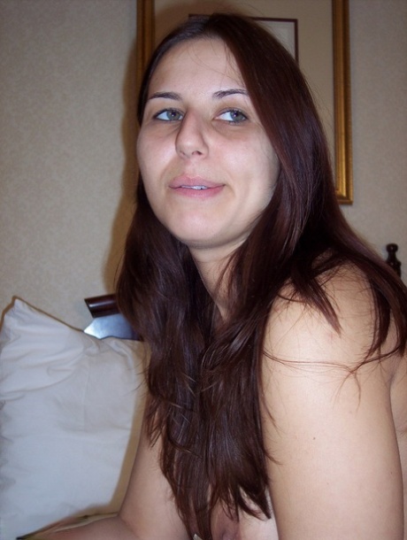 Totally naked girl Lexxxi sits on her bed while smoking a cigarette