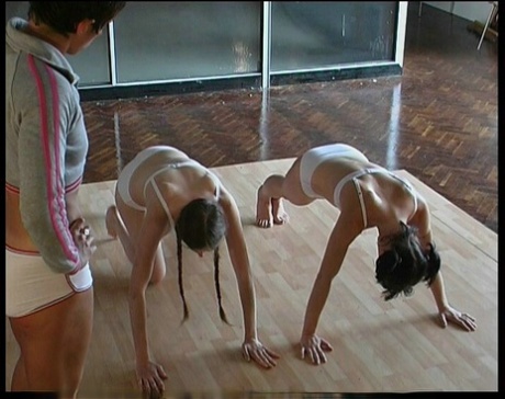 Two girls receive a brutal paddling and caning from a dyke that gets off on it