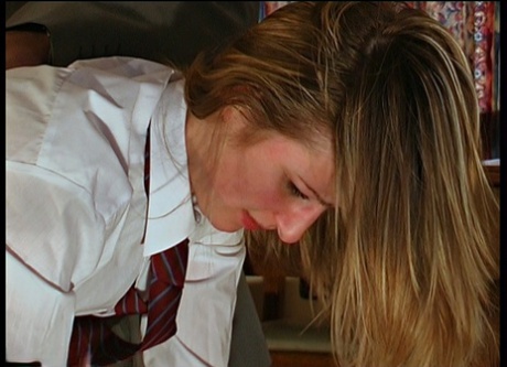 Misbehaving student gets bent over a man's knee for a hard spanking