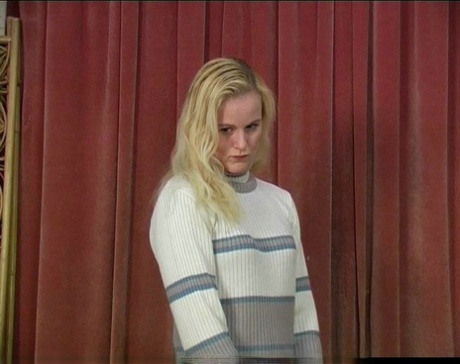 Blonde teen has her bare ass turned red during a caning session