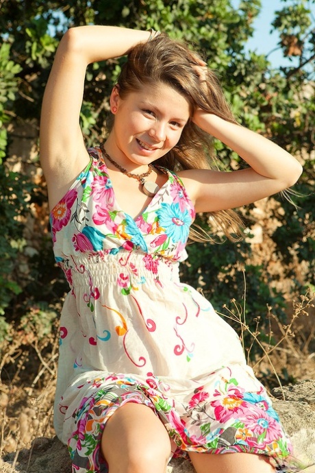 Sweet young girl takes off her dress while getting naked outdoors in sandals