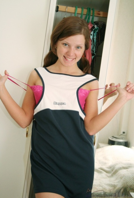 Young looking girl gets naked in front of a mirror for her first nudes