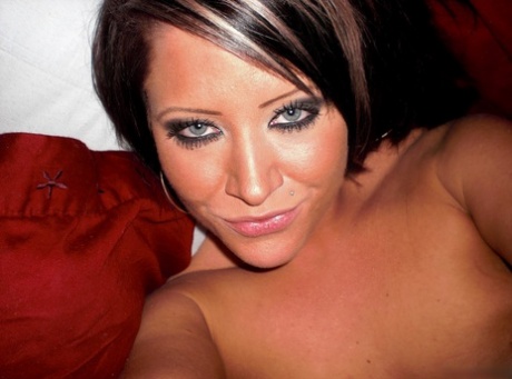 Amateur chick takes self shots while getting totally naked on her bed