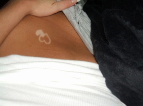 Blonde amateur removes her pants while taking self shots