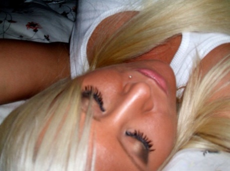 Blonde amateur removes her pants while taking self shots